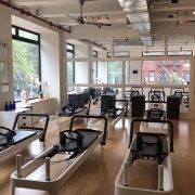 empty workout room filled with pilates reformers