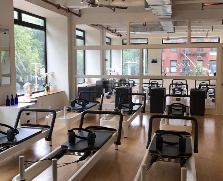 empty workout room filled with pilates reformers