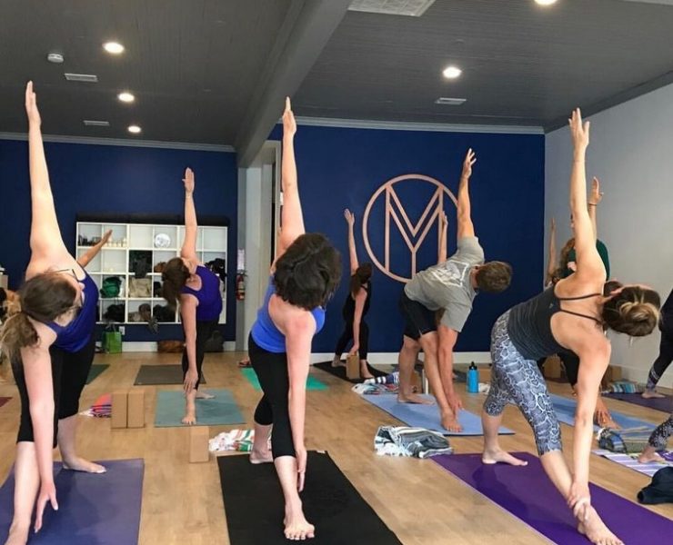 big room with people practicing yoga