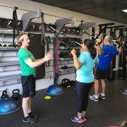 three people working out using TRX