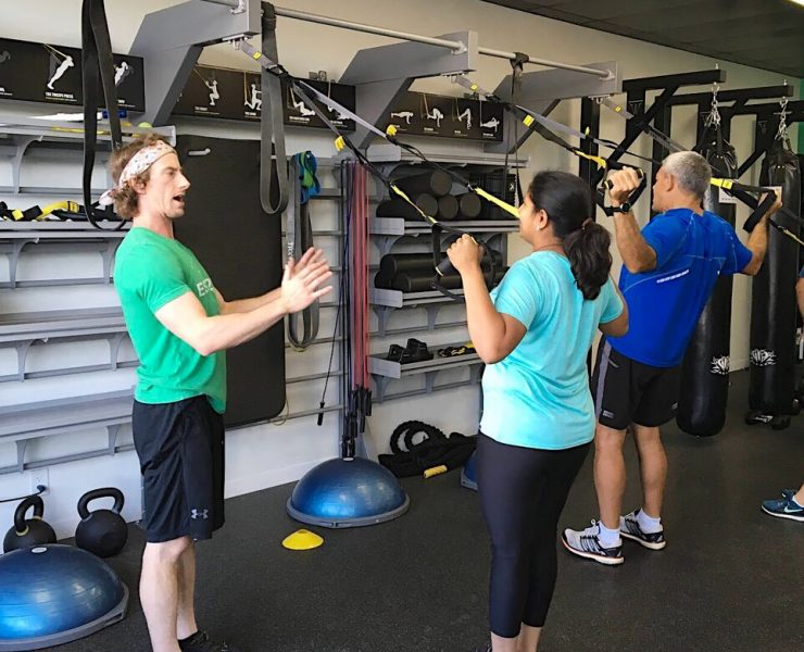three people working out using TRX