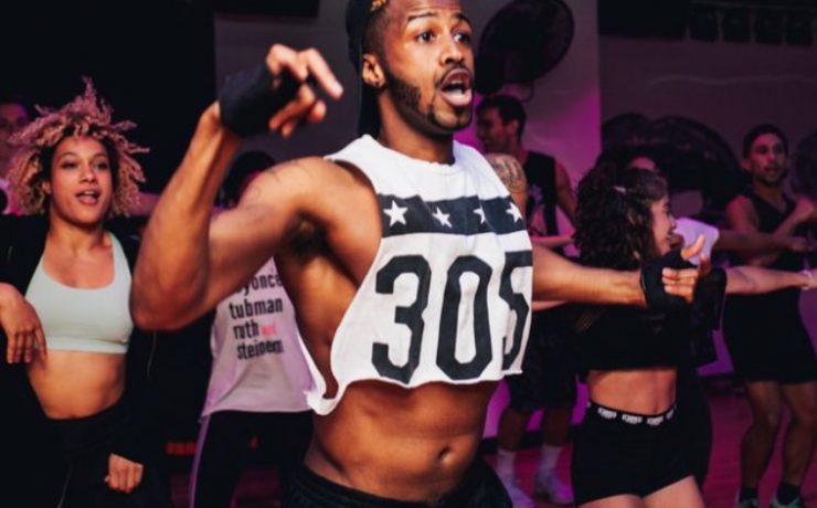 man dancing in white crop top and black pants