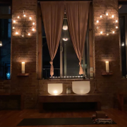 Yoga shala in the dark, lit up by candle light