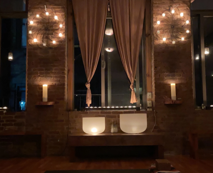 Yoga shala in the dark, lit up by candle light