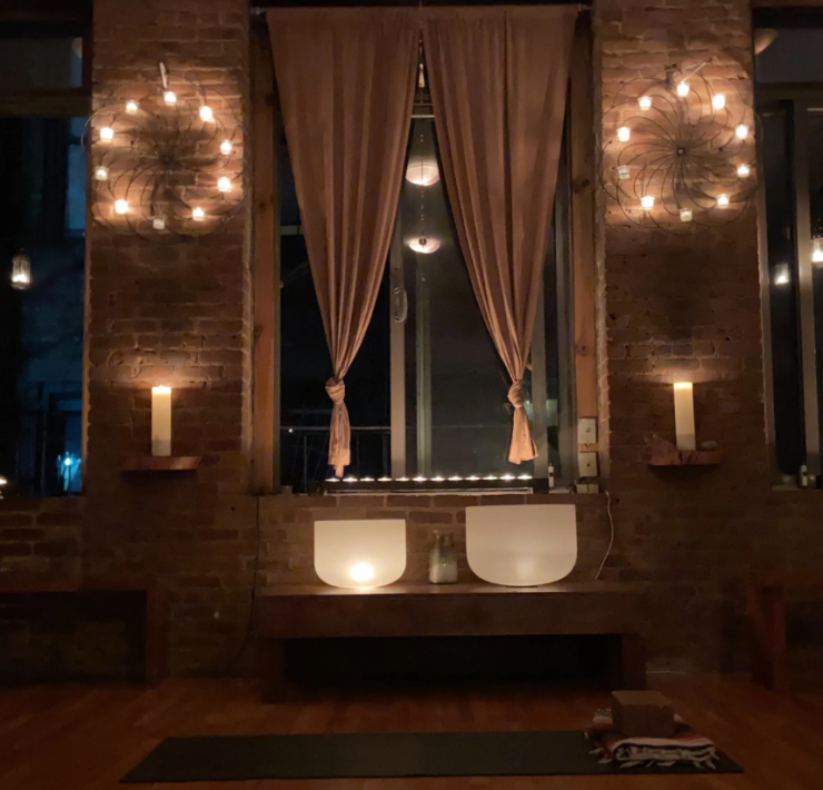 Yoga shala in the dark, lit up by candle light